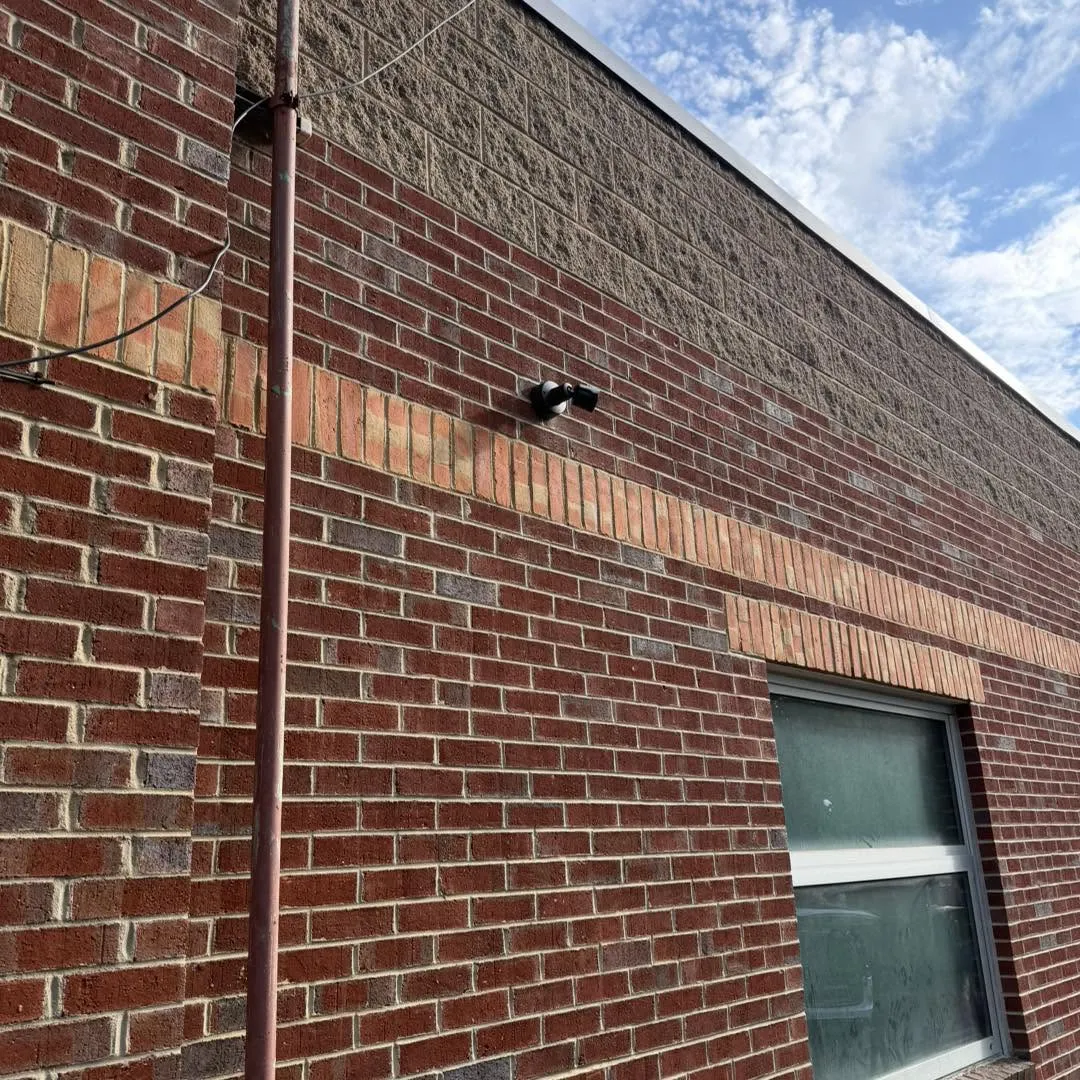 Commercial security camera mounted on a brick wall at Rally House by Zaxx Tech Solutions