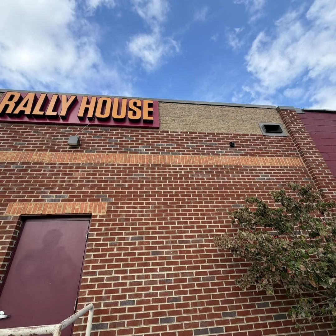 Rally House commercial surveillance camera installation by Zaxx Tech Solutions on the brick storefront