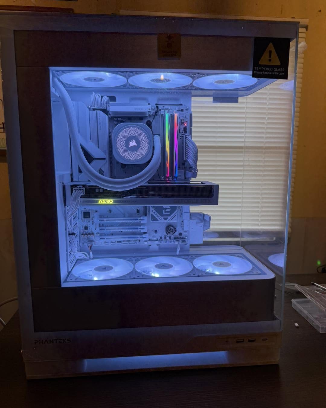 Custom gaming PC built in-house in a Phanteks case with white AIO cooler and blue RGB lighting