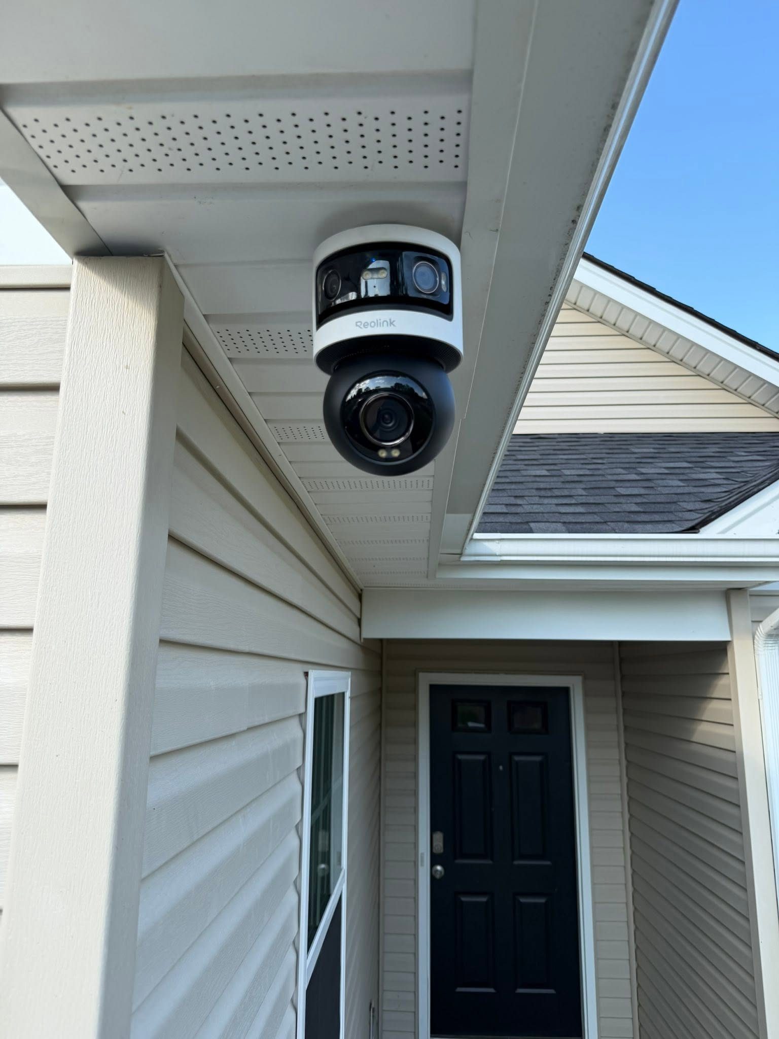 Reolink dual-lens security camera professionally installed under the eaves of a Virginia home