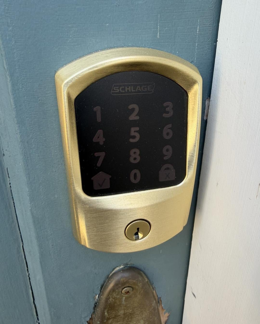 Schlage smart deadbolt lock with keypad installed on a home front door