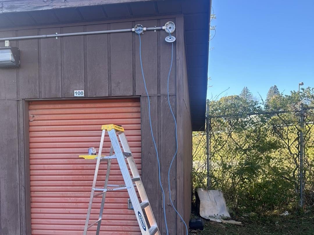 Low voltage cabling and conduit run cleanly to a storage facility exterior wall