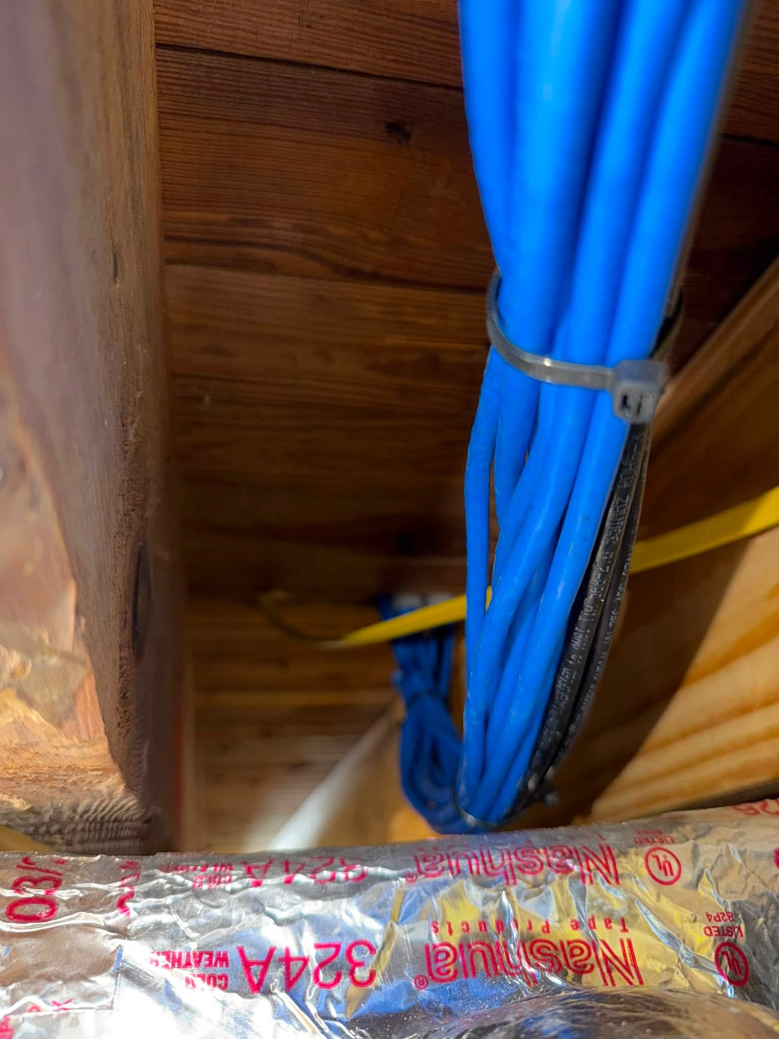 Bundle of Cat6 structured cabling run cleanly through attic joists during a new-construction prewire